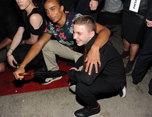 In this Tuesday, June 18, 2013 file photo, Madonna's son, Rocco Ritchie, foreground, attends the world premiere of &quot;Madonna: The MDNA Tour&quot; at the Paris Theatre in New York. Madonna is apologizing for using a racial slur to refer to her white son Instagram. On Friday night, Jan. 17, 2014, she posted a picture of her 13-year-old son boxing and used a hashtag that contained a racial slur.