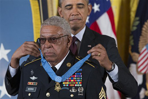 Staff Sgt. Melvin Morris is awarded the Medal of Honor by President Barack Obama during a ceremony in the East Room of the White House in Washington, Tuesday, March 18, 2014.