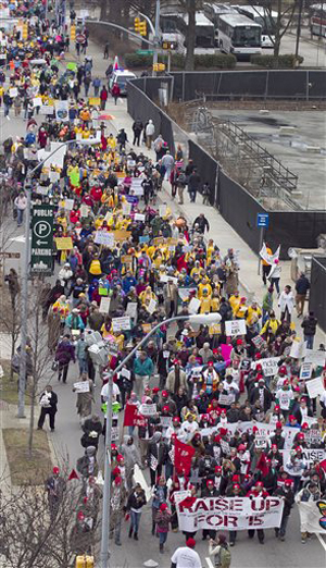 Marchers walk down Wilmington Street just before noon during the annual HKonJ People's Assembly on Saturday, Feb. 8, 2014 in Raleigh, N.C. Also known as the &quot;Moral March on Raleigh&quot;, participants marched to the Capital to rally against policies adopted by the legislature last year.