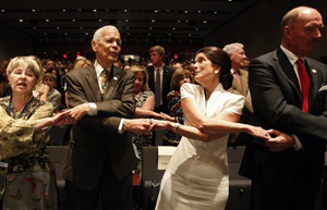 Social activist Julian Bond and Luci Baines Johnson hold hands as the crowd sings along &quot;We Shall Overcome,&quot; during the Civil Rights Summit at the LBJ Presidential Library in Austin, TX on Wednesday, April 10, 2014. President Barack Obama, celebrating a half-century of the Civil Rights Act, used the image of Lyndon B. Johnson to urge perseverance and courage to move civil rights forward.