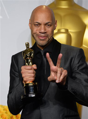 John Ridley poses in the press room with the award for best adapted screenplay of the year for &quot;12 Years a Slave&quot; during the Oscars at the Dolby Theatre on Sunday, March 2, 2014, in Los Angeles.