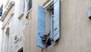window with blue shutters and flowers