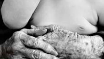 hands of an elder holding a baby