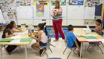 This photo taken July 21, 2014 shows students in Jane Cornell's summer school class learn story telling skills at Mary D. Lang Kindergarten Center in Kennett Square, Pa. For the first time ever U.S. public schools are projected this fall to have more minority students enrolled than white, a shift largely fueled by growth in the numbers of Hispanic children.