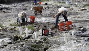 People work at a site in downtown Miami, Tuesday, Feb. 4, 2014, which is likely to be of the most significant prehistoric sites in the United States of Tequesta Indian dwellings, dating back 2,000 years.