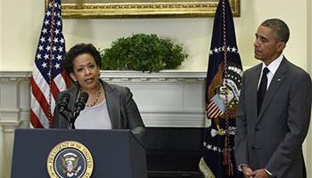 President Barack Obama listens as U.S. Attorney Loretta Lynch speaks after Obama nominated Lynch to be the Attorney General, Saturday, Nov. 8, 2014, in the Roosevelt Room of the White House in Washington. Lynch would succeed Attorney General Eric Holder.