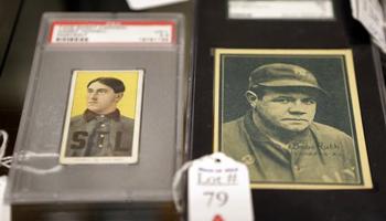 In this photo made Tuesday, March 11, 2014, baseball cards of major leaguers Harry Howell, left, and Babe Ruth are seen at the Saco River Auction House in Biddeford, Maine. The auction house is getting a reputation for selling some of the nation's oldest baseball memorabilia.