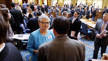 In this May 22, 2014 photo, New Jersey Assemblywoman and congressional candidate, Bonnie Watson Coleman, center, D-Trenton, N.J., stands on the floor of the assembly before a session at the Statehouse in Trenton, N.J. More than 100 black candidates will be on the ballot in statewide and congressional races next month, a post-Reconstruction record that some observers say is a byproduct of President Barack Obama’s historic presidency.