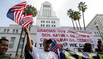 Ipolito Nurez celebrates outside City Hall after California Gov. Jerry Brown signed the bill AB 60, which allows immigrants in the country illegally to obtain driver licenses. Immigrant advocates have long lobbied for the change in the nation's most populous state so immigrants can drive without fearing being pulled over for a ticket, which could wind up getting them deported.