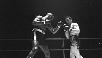 In this Feb. 23, 1965 file photo, Rubin "Hurricane" Carter, left, knocks out Italian boxer Fabio Bettini in the 10th and last round of their fight at the Falais Des Sports in Paris. Carter, who spent almost 20 years in jail after twice being convicted of a triple murder he denied committing, died at his home in Toronto, Sunday, April 20, 2014.