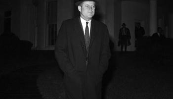 In this Dec. 19, 1961 file photo, President John F. Kennedy leaves the White House in Washington to Andrews Air Force Base for flight to Palm Beach, Fla. en route to the bedside of his father, Joseph P. Kennedy, who is hospitalized after suffering as stroke. Kennedy's civil rights legacy has undergone substantial reassessment since his 1963 assassination. Half a century later, "We're still trying to figure it out," says one longtime civil rights activist.