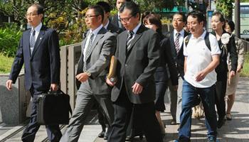 A group of plaintiffs arrive at the Kyoto District Court in Kyoto, western Japan, Monday, Oct. 7, 2013 for a verdict over a case they filed against a group of anti-Korean activists. The Japanese court ordered the activists to pay a Korean school in Kyoto 12 million yen ($120,000) in compensation Monday for disturbing classes and scaring children by holding "hate speech" rallies outside the school.