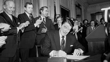 In this June 30, 1982 photo, President Ronald Reagan signs an expansion of the 1965 Voting Rights Bill during a ceremony in the East Room of the White House.