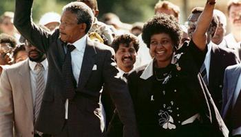 In this Feb. 11, 1990, file photo, Nelson Mandela and his wife, Winnie, raise clenched fists as they walk hand-in-hand upon his release from prison in Cape Town, South Africa. South Africa's president says, Thursday, Dec. 5, 2013, that Mandela has died. He was 95.