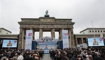 German Chancellor Angela Merkel delivers her speech at a rally against anti-Semitism near the Brandenburg Gate in Berlin, Sunday, Sept. 14, 2014 after tensions over the Gaza conflict spilled over into anti-Jewish demonstrations and violence in Europe. The slogan reads: Stand Up! - Jew hatred - never again!', and the name of the organizer: Central Council of Jews in Germany.