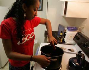 the author stirring a pot atop an oven