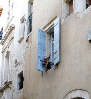 window with blue shutters and flowers