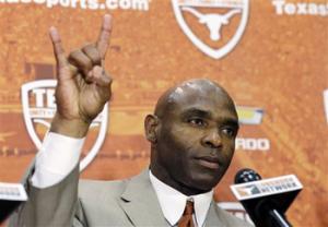 Charlie Strong holds up the "Hook'em Horns" hand signal during an NCAA college football news conference where he was introduced as the new Texas football coach, Monday, Jan. 6, 2014, in Austin, Texas. Strong acknowledged the historical significance of being the school's first African-American head coach of a men's sport. He takes over for Mack Brown, who stepped down last month after 16 seasons.