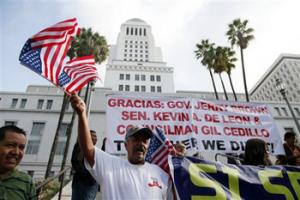 Ipolito Nurez celebrates outside City Hall after California Gov. Jerry Brown signed the bill AB 60, which allows immigrants in the country illegally to obtain driver licenses. Immigrant advocates have long lobbied for the change in the nation's most populous state so immigrants can drive without fearing being pulled over for a ticket, which could wind up getting them deported.