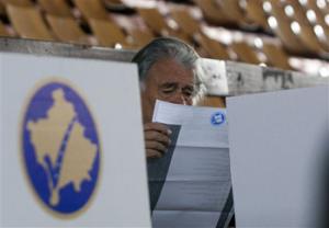 A Kosovo ethnic Albanian man looks at the ballot at a polling station in the Kosovo capital of Pristina before casting his vote Sunday, Nov 3, 2013. People in Kosovo are voting in a local election that will test the country's fragile relations with Serbia as both seek to move closer to the European Union. Serb participation in Kosovo's political life is a key element of an EU-brokered deal that seeks to settle the dispute over Kosovo and unlock EU funds.