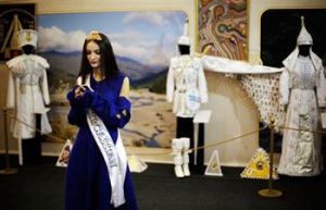 In this photo taken Friday, Feb. 14, 2014, Bella Kukan, Miss Circassia from the town of Maikop, waits to greet visitors during a folk theatre troupe performance at the Circassian House in Olympic Park at the 2014 Winter Olympics in Sochi, Russia. The Circassians, an ethnic group indigenous to the land now hosting the Olympics, are using the games to call the world’s attention to their culture and history, which includes massacres by imperial Russian armies and persecution by Stalin.