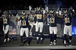 Members of the St. Louis Rams raise their arms in awareness of the events in Ferguson, Mo., as they walk onto the field during introductions before an NFL football game against the Oakland Raiders, Sunday, Nov. 30, 2014, in St. Louis. The players said after the game, they raised their arms in a "hands up" gesture to acknowledge the events in Ferguson.