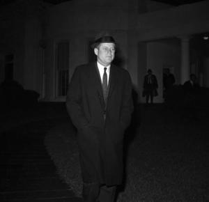 In this Dec. 19, 1961 file photo, President John F. Kennedy leaves the White House in Washington to Andrews Air Force Base for flight to Palm Beach, Fla. en route to the bedside of his father, Joseph P. Kennedy, who is hospitalized after suffering as stroke. Kennedy's civil rights legacy has undergone substantial reassessment since his 1963 assassination. Half a century later, "We're still trying to figure it out," says one longtime civil rights activist.