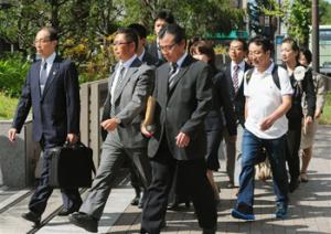 A group of plaintiffs arrive at the Kyoto District Court in Kyoto, western Japan, Monday, Oct. 7, 2013 for a verdict over a case they filed against a group of anti-Korean activists. The Japanese court ordered the activists to pay a Korean school in Kyoto 12 million yen ($120,000) in compensation Monday for disturbing classes and scaring children by holding "hate speech" rallies outside the school.