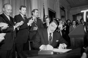 In this June 30, 1982 photo, President Ronald Reagan signs an expansion of the 1965 Voting Rights Bill during a ceremony in the East Room of the White House.