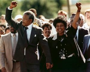 In this Feb. 11, 1990, file photo, Nelson Mandela and his wife, Winnie, raise clenched fists as they walk hand-in-hand upon his release from prison in Cape Town, South Africa. South Africa's president says, Thursday, Dec. 5, 2013, that Mandela has died. He was 95.