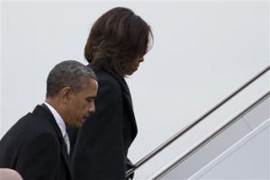 President Barack Obama and first lady Michelle Obama board Air Force One to travel to South Africa for a memorial service in honor of Nelson Mandela on Monday, Dec. 9, 2013 in Andrews Air Force Base, Md.