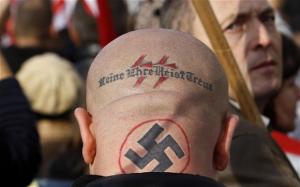 tattoo of a swastika and neo-Nazi slogan