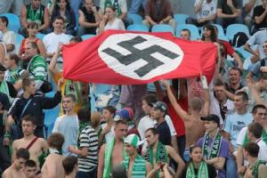 soccer fans holding a Nazi flag